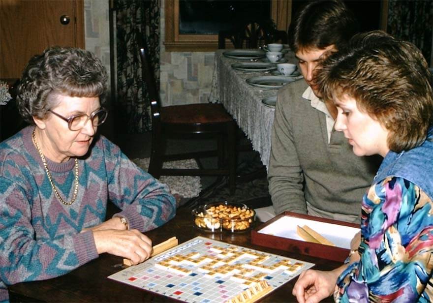 Family playing Scrabble together at home in the 1980s